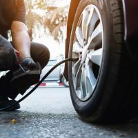 Mechanic checks tire pressure